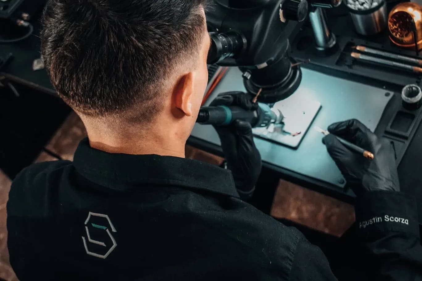 Agustín Scorza trabajando en el laboratorio, con el logo de ASC Service en la ropa